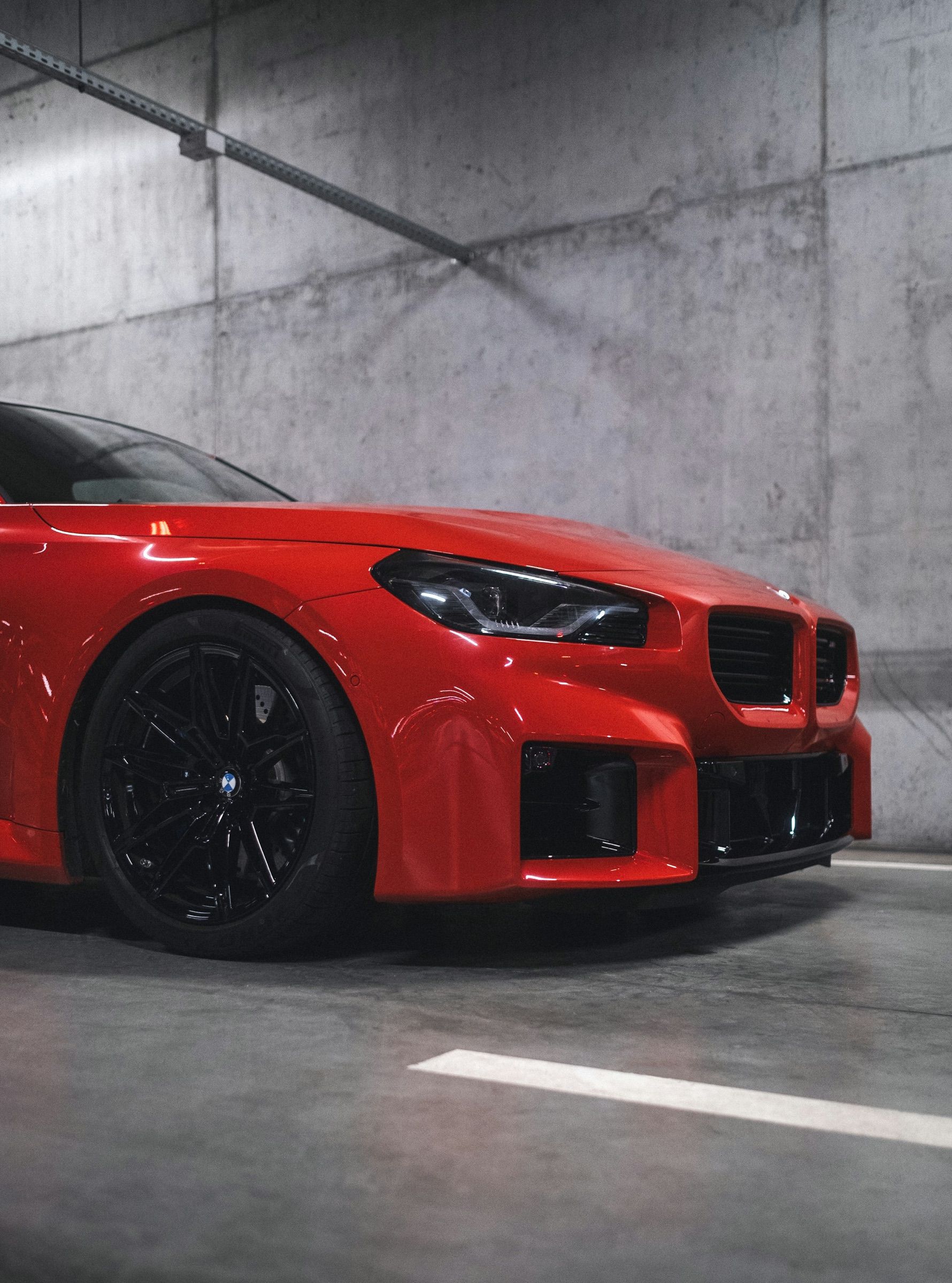 Czerwone auto sportowe w betonowym garażu
